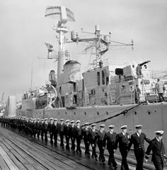 Royal Australian Navy personnel march aboard the newly commissioned HMAS Yarra, 1961.