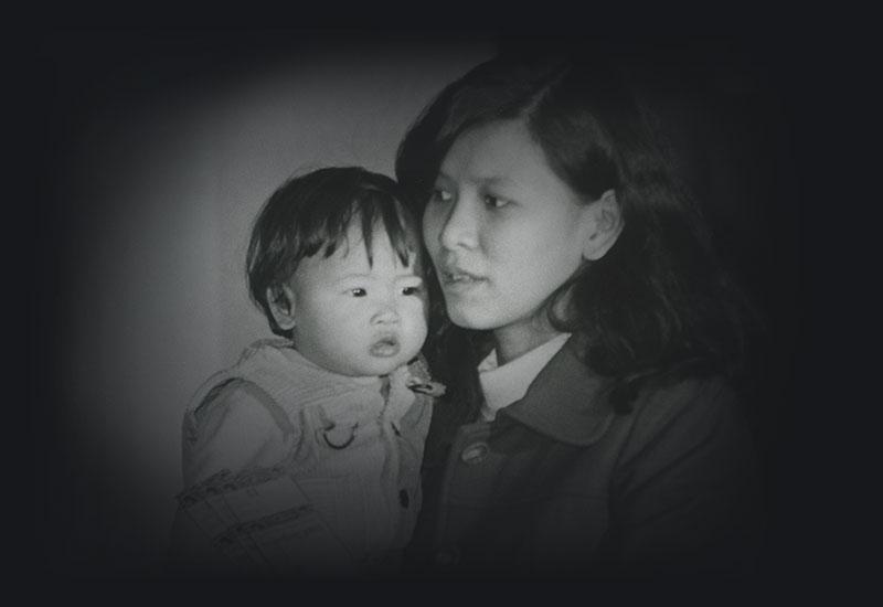 A Vietnamese woman holding a child