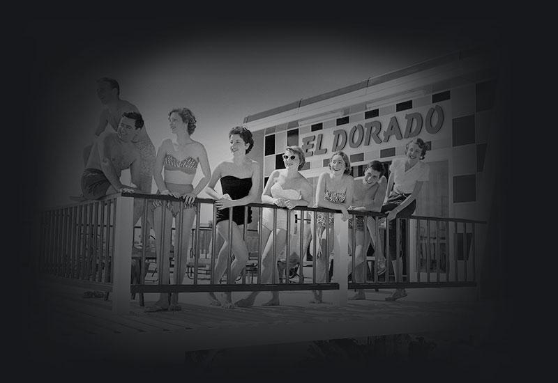 Young people wearing swimming costumes, leaning on a railing at the El Dorado Motel
