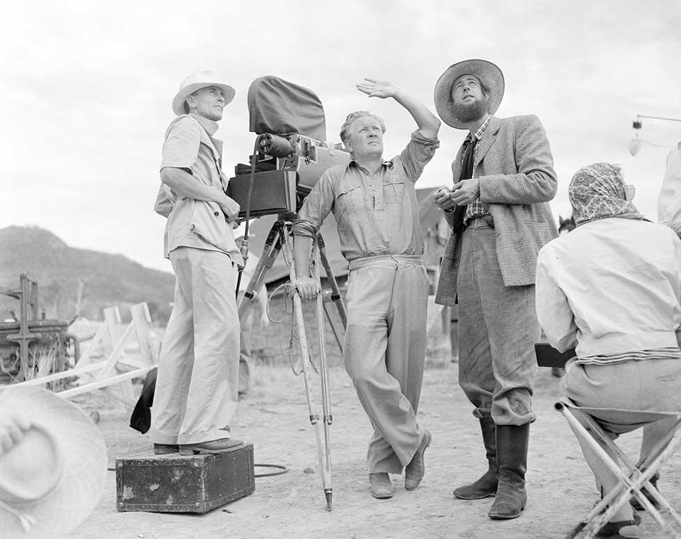 George Heath (left), Chips Rafferty (right) and a man in the centre captioned only as 'Haring', who may be Harry Watt, the film director.