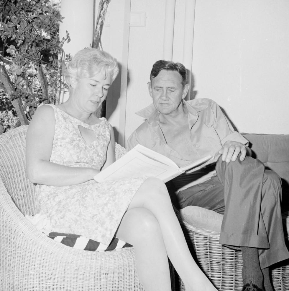 John and Bettina Gorton relax on cane chairs and read books together at The Lodge.