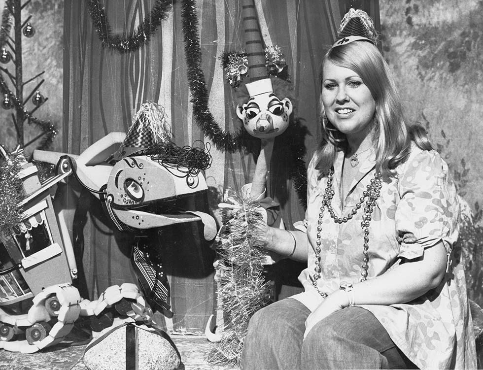 Two marionette puppets and television co-host.