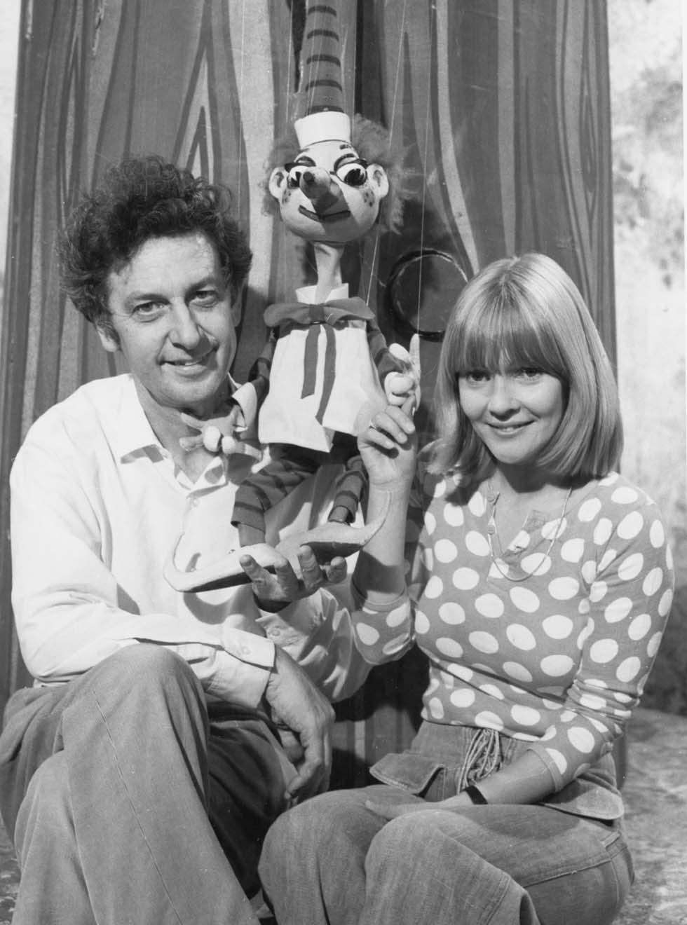 A marionette puppet pictured with it's creator and two television co-hosts 