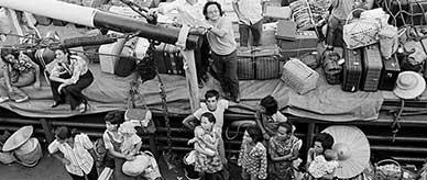 East Timorese refugees: men, women and children on the decks of a freighter, along with their luggage.