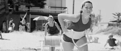 A member of the Neptune Ladies Lifesaving Club heads into the water