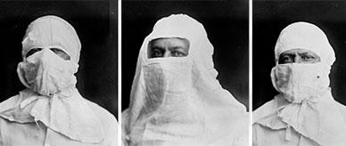 Three adults wearing different quarantine garments over their head and face.