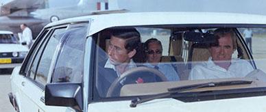 Prince Charles at the wheel of a white Commonwealth Ford LTD, Richmond RAAF Base