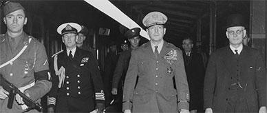 General MacArthur and John Curtin walking along a railway platform