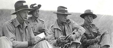 Four men of the Volunteer Defence Corps relaxing on the grass.