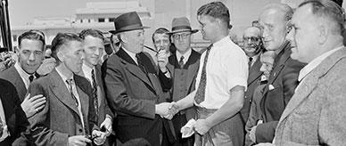 British migrant tradesman shakes hands with Prime Minister Ben Chifley.