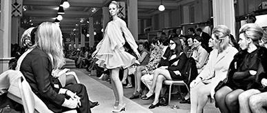 A woman modeling a Jean Patou dress at Georges fashion store.
