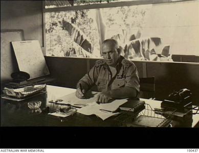 Veale at his desk in Port Moresby during WWII.