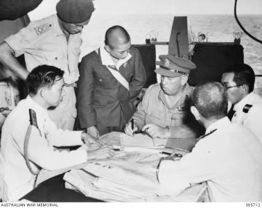Veale with Japanese officers after the surrender ceremony aboard HMS Glory in 1945.
