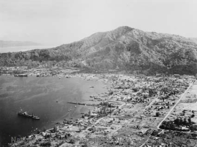 Elevated view of a ship in Rabaul harbour and mountain in the background.
