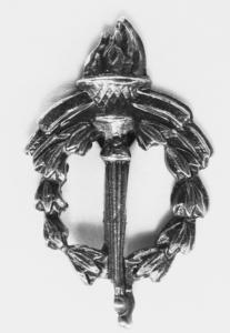 Cast metal badge depicting a flaming torch encircled with a wreath.