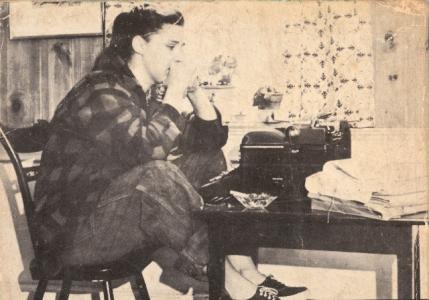 Author Grace Metalious sitting at her typewriter.